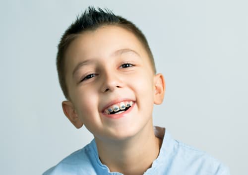 Young boy with missing teeth smiling joyfully – Basking Ridge and Mendham, NJ – Banasiak & Nettune