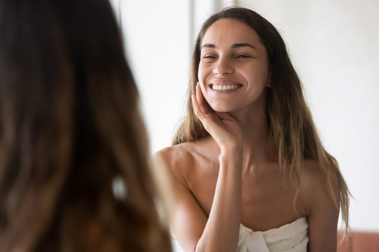 Young woman smiling confidently in mirror