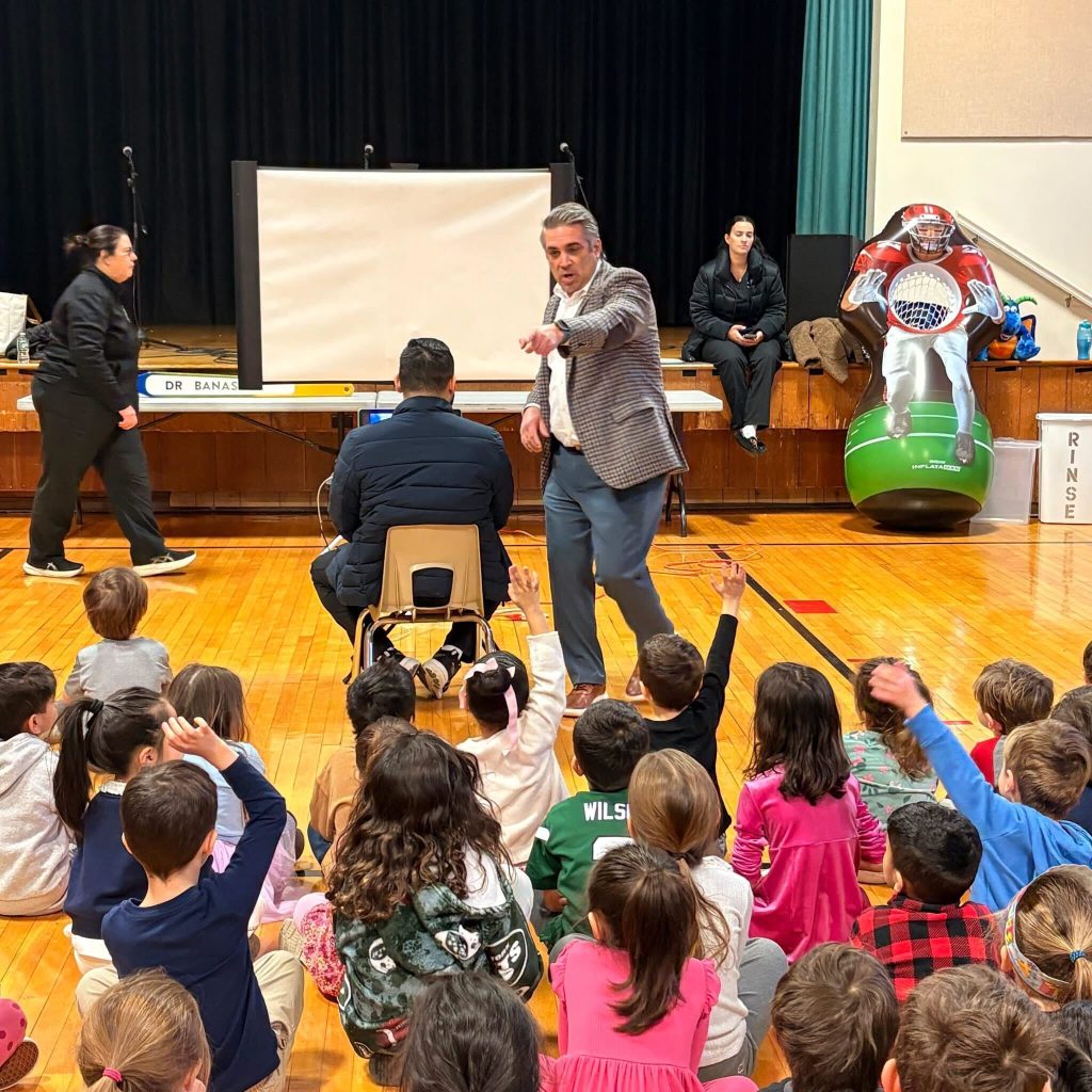 Dentist, Dr. Kenneth Banasiak teaching children about proper oral hygiene and healthy eating habits