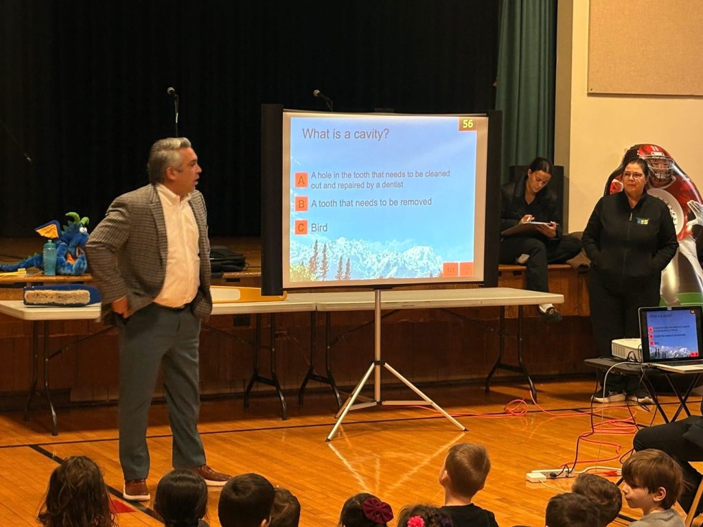 Dentist, Dr. Kenneth Banasiak teaching children about proper oral hygiene and healthy eating habits