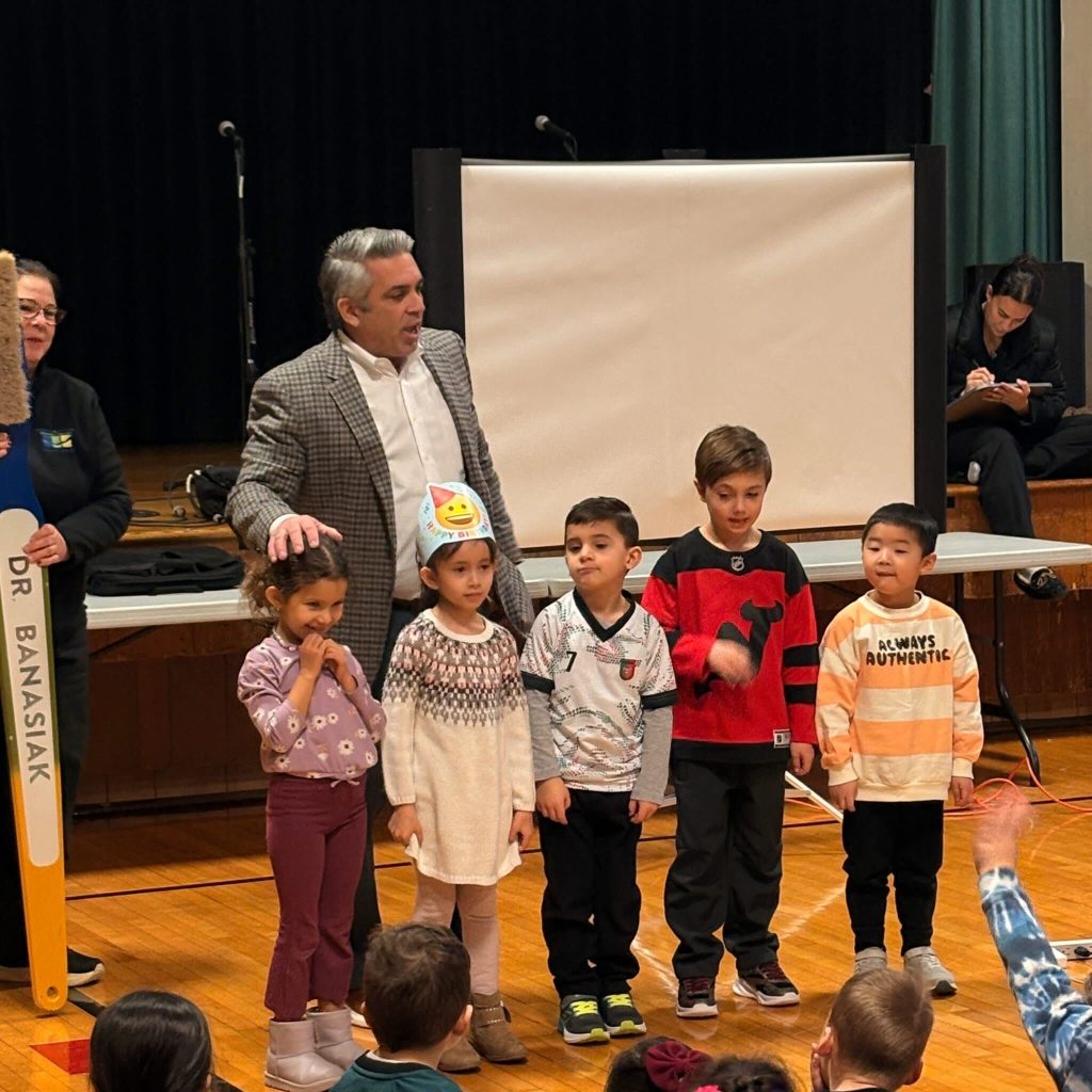 Dentist, Dr. Kenneth Banasiak teaching children about proper oral hygiene and healthy eating habits